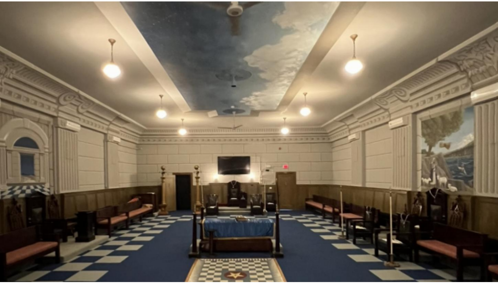 The temple rebuilt. An image of the Fulton Friendship lodge room from the point of view of the east. Filled with ample seating and beautiful mural work.